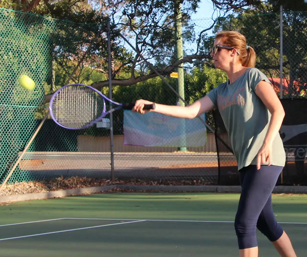 Adult female playing tennis forehand