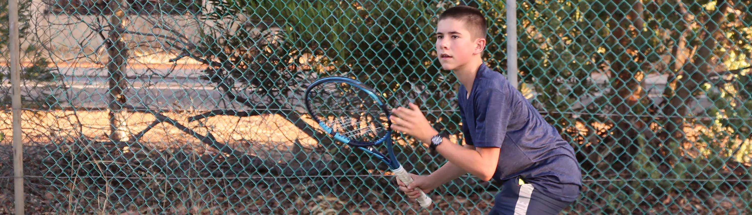 Boy playing tennis
