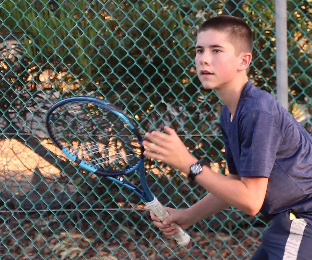 Boy playing tennis